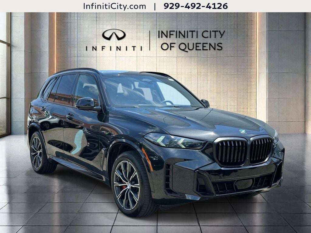 2025 BMW X5 xDrive40i in Black Sapphire Metallic — front three-quarter view